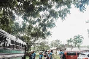 Team hopping off a bus in Belize.